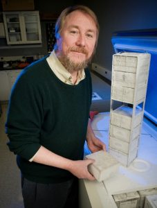 Richard Lenski pulls frozen bacteria cultures out of a freezer in the lab on Thursday October 15, 2009. poses in the lab on Thursday October 15, 2009.